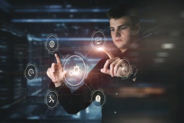 Bir programcı bulanık bir arkaplana karşı sanal bir bilgisayar ekranında bir program geliştirir.