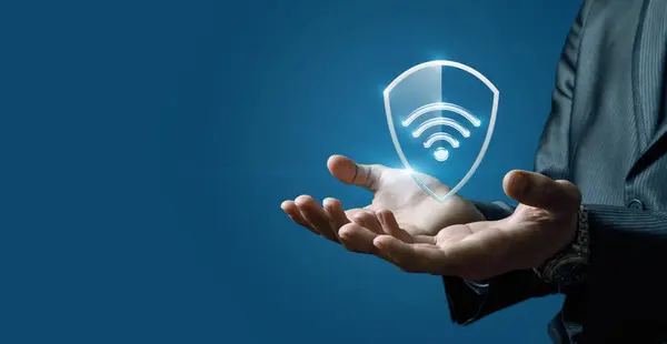 Concept of wireless network protection. Hands show a shield for a wireless network.