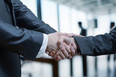 İş adamları bulanık ofis geçmişine karşı el sıkışıyor.