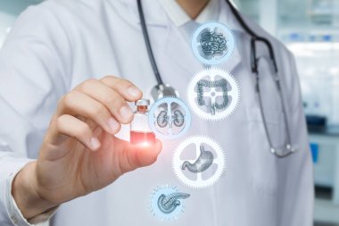 Laboratuvar önlüğü giymiş bir tıp uzmanı elinde bir şişe ilaç tutarken, yakınlarda çeşitli organların görsel temsilleri yüzüyor ve sağlık ve tedaviye odaklandığını gösteriyor..