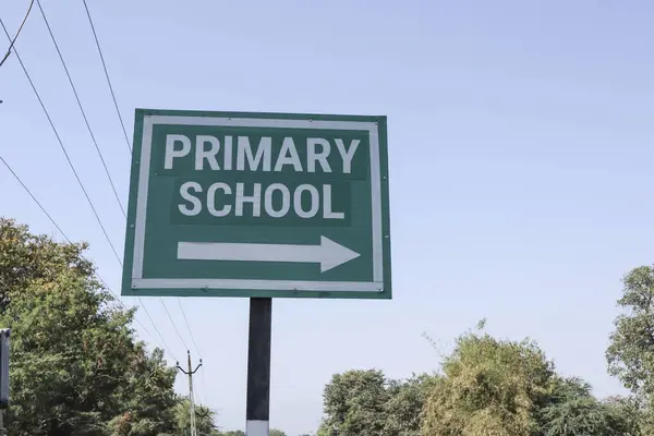 Road sign written Primary School with right side arrow. Primary school signal post on green board