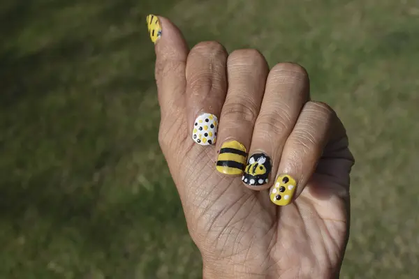 Creative Nail Art with Bee theme. Nail art designs, Bee hive designs with stripes, dots pattern on Yellow, black and white colors