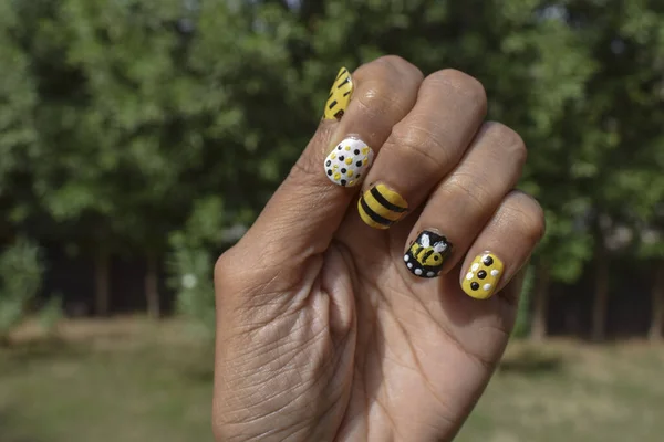 Creative Nail Art with Bee theme. Nail art designs, Bee hive designs with stripes, dots pattern on Yellow, black and white colors