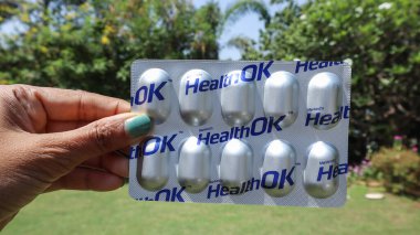 Health OK tablet is Multivitamin and Multimineral Capsules in strip of 10 tablets clipart