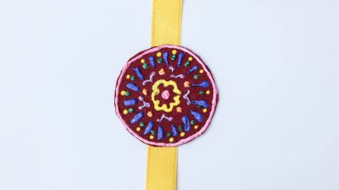 Beautiful and unique handmade rakhi made with lade, rhinestones and ribbon clipart