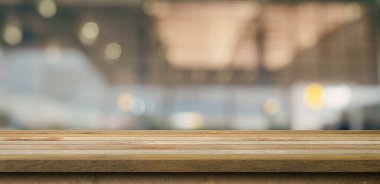 Empty wooden table anb Abstract blur airport interior for backgounrd 
