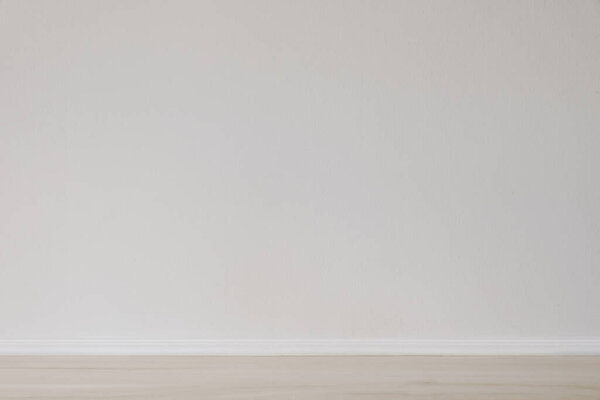 Modern interior mockup. Simple background with empty beige wooden floor and blank white wall. Scandinavian home. Space, room for product display, house. Apartment. Indoor architecture concept.