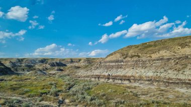 Drumheller, Alberta, Canada - August 06 2024: Area of the badlands as viewed from the viewing platform near the Royal Tyrrell Museum in Drumheller, Alberta. clipart