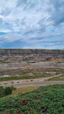 Drumheller, Alberta, Canada - August 06 2024: Area of the badlands as viewed from the viewing platform near the Royal Tyrrell Museum in Drumheller, Alberta. clipart