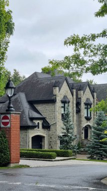 Montreal, Canada - july 2023 : Front view of a pretty house surrounded by trees clipart