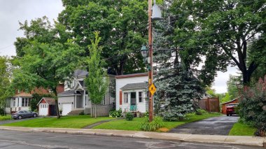 Montreal, Canada - july 2023 : Front view of a pretty house surrounded by trees clipart