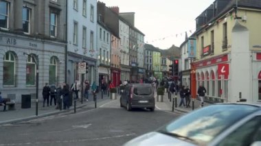 İrlanda 'daki Kilkenny Town Center Caddesi. İnsanlar ve arabalar, restoranlar ve dükkanlar. Geniş açı. Yüksek kalite 4K görüntü. Geniş açı