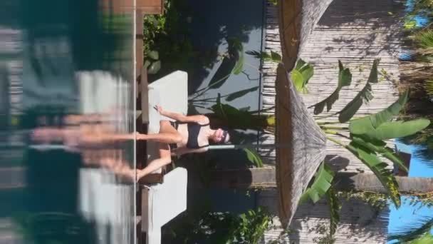 Vertical Video Stories Reels Beautiful Woman Sunbathing Beach Pool Blue — Stock Video