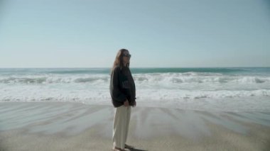 Güzel bir Kleopatra Sahili 'nde duran bir kadın. Tek başıma. Aralık. Hindi. Alanya 2021. Yüksek kaliteli FullHD görüntüler