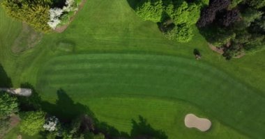 Havadan. Profesyonel ekipmanlı özel personel golf sahası hazırlıyor, yeşil çimen kesiyor, yeni golf delikleri açıyor, yeni av sezonu için sığınaklardaki kumu temizliyor. Yüksek kalite 5k görüntü