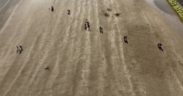 Люди Ходят Пляжу Пролетает Над Широким Песчаным Пляжем Траморе Закате — стоковое видео