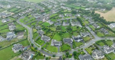 Havadan. Tramore 'daki okyanus kıyısındaki sisli özel evlerin üzerinden uç. Sisli bir gün. Tramore, Waterford, İrlanda. Yüksek kalite 4k görüntü
