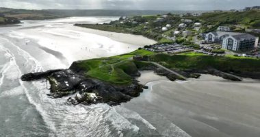 Havadan. Geniş kumlu plaj, amfi tiyatro ve geniş araba parkı geniş kumlu plaj. Okyanusun mavi dalgaları. Mavi okyanus suyu denizden esen güçlü rüzgar. Inchydoney Sahili, Clonakilty Yüksek Kaliteli 4K görüntü