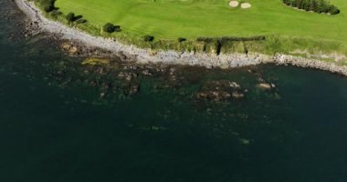 Okyanus ve Plaj yakınlarındaki Güzel Lüks Yaşam Tarzı Costal Golf Sahasının 4K Hava Dronu. Okyanusun yakınındaki kayalık bir kayalıkta resim gibi bir golf sahası. Gold Coast Golf Kulübü. Waterford Köyü