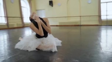 Sivri ayakkabılı profesyonel balerin ve siyah bale elbisesi çok güzel dans figürleri gösteriyor. Büyük salonda klasik balerin unsurlarıyla dans eden zarif balerin. Dans stüdyosu sahne ışığıyla