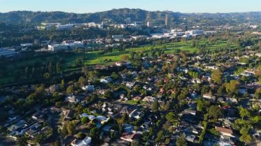 Los Angeles, Kaliforniya 'daki Toluca Gölü ve Burbank siluetinin nefes kesici 4K hava görüntüsü, altın sabah ışığı sırasında çekildi. Görüntülerde lüks evler, bereketli yeşillikler ve huzur sergileniyor.