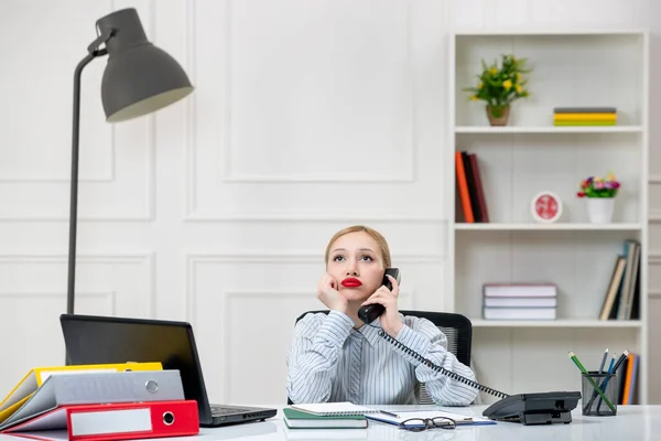 secretary cute lovely blonde young girl in shirt in office with work load thinking of work