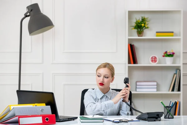 secretary working in office cute lovely blonde young girl in shirt with work load on phone
