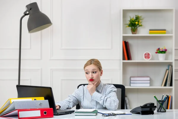 secretary working in office lovely cute blonde young girl in shirt with work load thinking