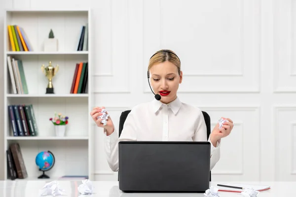 stock image customer service cute blonde girl office shirt with headset and computer holding a crumbled paper