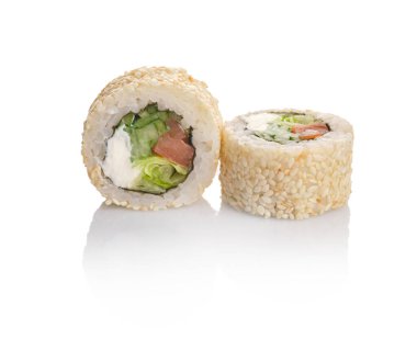 Somon, krem peynir ve marul dolu susamlı iki lezzetli suşi rulosu taze malzemeler ve canlı renkler sergiliyor..