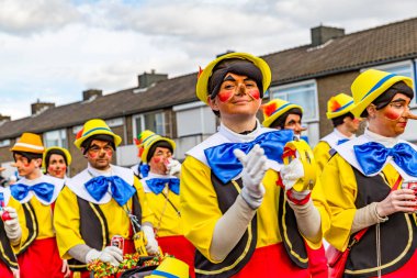 Beek, Güney Limburg, Hollanda. 3 Mart 2014. Pinokyo gibi giyinmiş insanlar, sarı, kırmızı, mavi ve kahverengi elbiseler giyip, kalabalığın içinden geçerek karnavalın tadını çıkarıyorlardı.