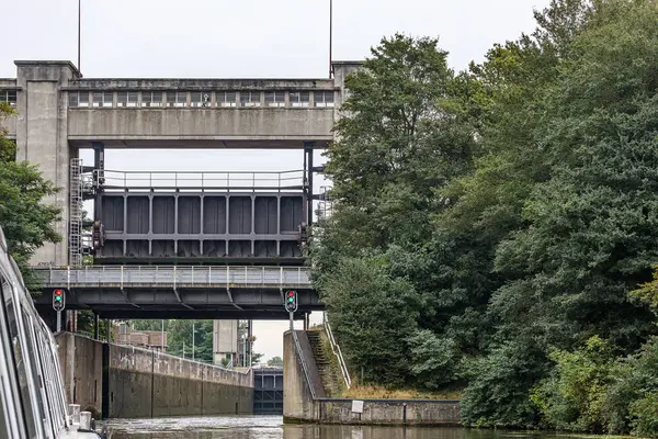 stock image Navigation canal at Bosscherveld lock, bridges at entrance and exit gates, red and green traffic lights, river Meuse and Zuid-Willemsvaart canal, cloudy day in Maastricht, South Limburg, Netherlands