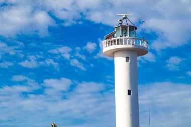 Deniz fenerinin bir kısmı ve tepesinde mavi gökyüzüne karşı dağınık beyaz bulutlar, aşağıdan görülen Loreto, Baja California Sur, Meksika 'da bulutlu bir gün.