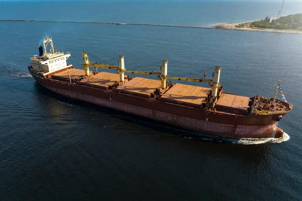 Large empty cargo ship in the sea during sunny summer day