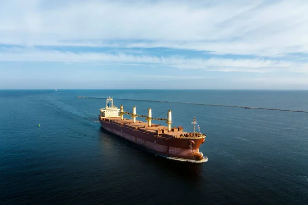 Large empty cargo ship in the sea during sunny summer day