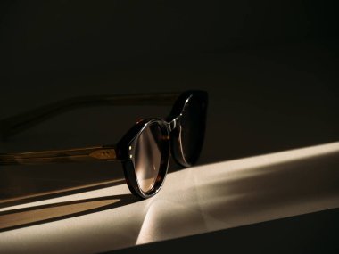 Trending form sunglasses on the table in beautiful morning sunlight