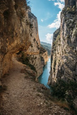 Hiking on Great Route, Footpath carved on the rock of Montrebei Gorge or Congost de Mont-rebei, Lleida, Catalonia, Spain.