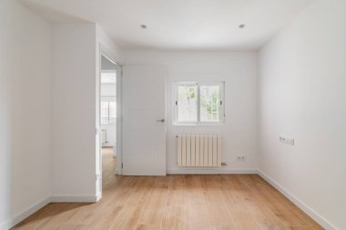 Empty white room with window and natural light. Interior of the freshly renovated room