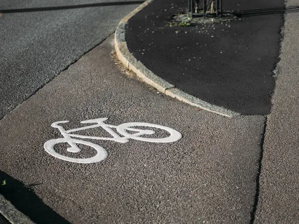 White bike path sign. Separate bicycle lane for riding bicycles. White painted bike on asphalt. Ride ecological green urban transport, healthy lifestyle concept
