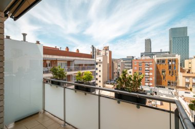 This vibrant Barcelona neighborhood showcases stunning architecture, balconies, and a beautiful cityscape against the backdrop of a cloudy sky. Discover the essence of Spain in this urban area. clipart