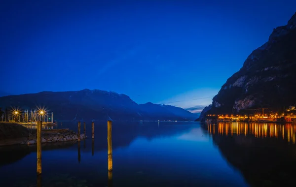 stock image Evening view on lake Garda in Riva Del Garda city, Italy. January 2023. Long exposure picture