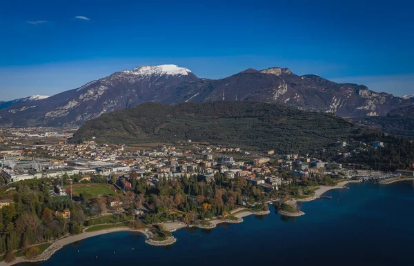 stock image The city of Riva del Garda, situated in the northern part of the largest Italian lake, Lago di Garda. Panoramic aerial view in January 2023