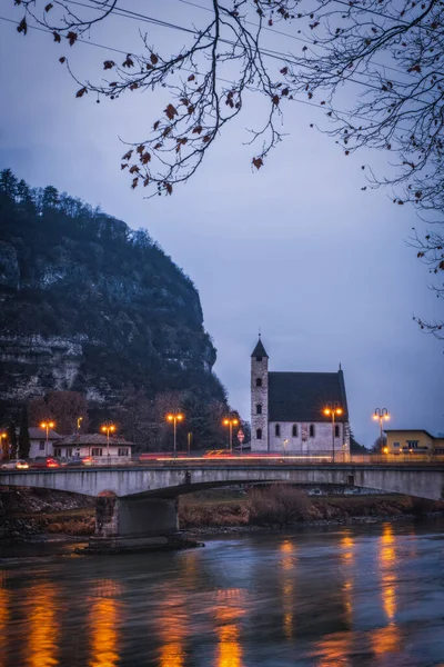 stock image Evening view of the city of Trento, Italy with snow capped mountain in background. Night view of a city between mountains and river. Long exposure picture. January 2023