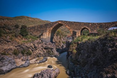 Ponte dei Saraceni. Simeto nehri üzerinde Norman çağına ait antik bir ortaçağ köprüsü. Adrano - Catania, Sicilya 'da. Uzun pozlama fotoğrafı. Haziran 2023