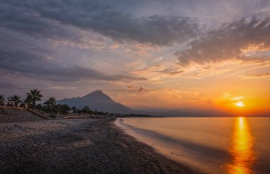 Sunset on the beach of the city of Campofelice di Rosaria in northwestern Sicily. August 2024 clipart