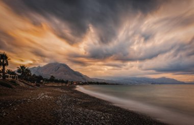 Sunset on the beach of the city of Campofelice di Rosaria in northwestern Sicily. August 2024. Long exposure picture. clipart