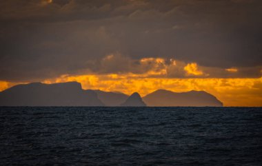 Picturesque view to a sunset sea gulf with beautiful mountains and amazing cloudy sky on background of nice travel landscape. Sicily, Campofelice di Roccella. August 2024 clipart