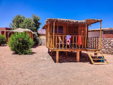 Cottage in a Bedouin Camp on the Sea in Ras Shitan in Oasis in Sinai, Taba desert with the Background of the Sea and Mountains.