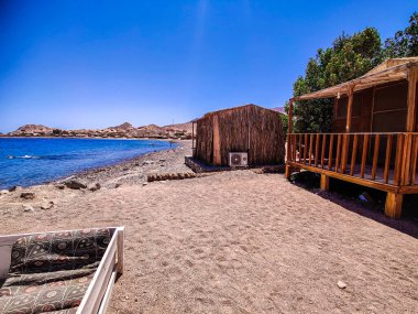 Cottage in a Bedouin Camp on the Sea in Ras Shitan in Oasis in Sinai, Taba desert with the Background of the Sea and Mountains.