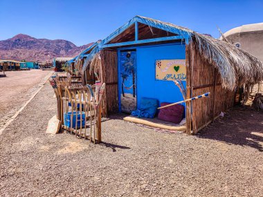 Cottage in a Bedouin Camp on the Sea in Ras Shitan in Oasis in Sinai, Taba desert with the Background of the Sea and Mountains.